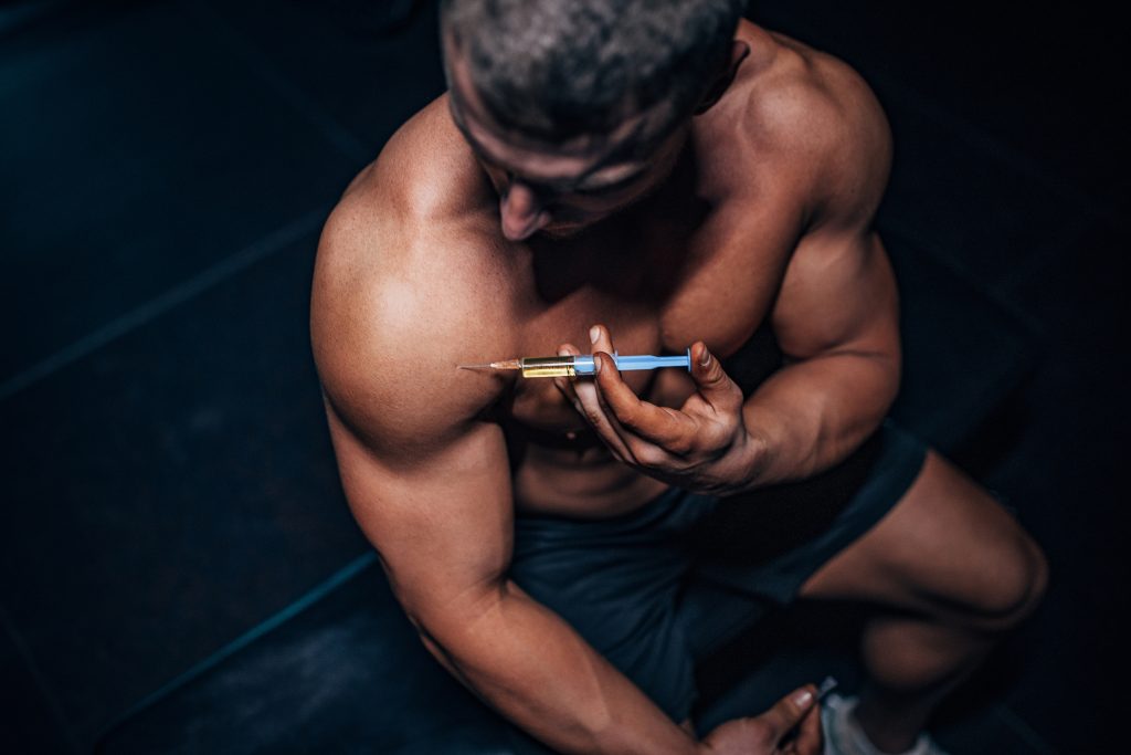 Man injecting steroids in shoulder